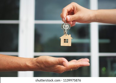 Home buyers are taking home keys from sellers. Sell your house, rent house and buy ideas.        - Shutterstock ID 1139975876