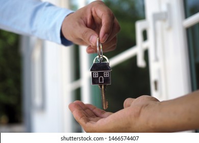 Home buyers are taking home keys from sellers. Sell your house, rent house and buy ideas.        - Shutterstock ID 1466574407