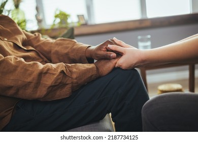 Home Caregiver And Senior Woman Holding Hands. Parkinson Disease Patient, Alzheimer Elderly Senior, Arthritis Person Hand In Support Of Nursing Family Caregiver Care For Disability Awareness Day