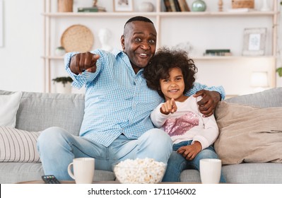 Home Cinema Concept. African American Family Of Grandfather And Grandchild Watching Television Together Indoors