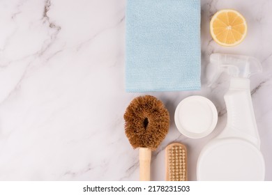 Home Cleaning Bundle With Natural Products For Green Household Over Marble Countertop Background With Copy Space. Eco-friendly Household Cleaning Set With Natural Tools, Coconut Brushes. Flat Lay