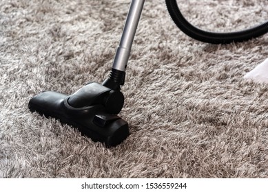 Home Cleaning Concept - Cleaning The Room With Carpet Sweeper In Close-up