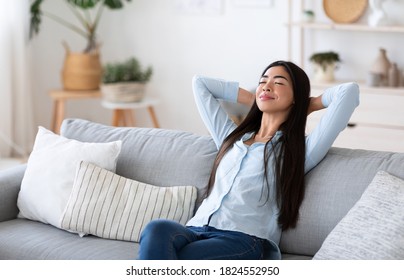 Home Comfort. Young Asian Lady Relaxing On Cozy Sofa In Living Room, Leaning Back On Couch With Closed Eyes And Hands Behind Head, Korean Female Enjoying Lazy Weekend And Day Off Indoors, Free Space - Shutterstock ID 1824552950