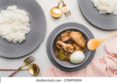 Home Cooked Chicken Adobo (Flat lay) is a Filipino dish stewed in vinegar, garlic, onion, soy sauce, bay leaves, peppercorns with some  boiled egg on the side. Best served with steaming white rice.