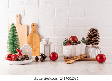 Home Countertop Kitchen Christmas decorations, balls, a mini Christmas tree, a lantern, a cones in a bowl, large cedar cone in a planter. Front view. - Powered by Shutterstock