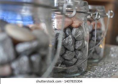 Home decoration. Rocks in jar. Home decoration jackstones in glass jar, close up of home decoration, little rocks in the glass jar. Sea jackstones and glass jar.