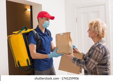 Home Delivering Food To Senior Citizens In Quarantine During Covid-19 Coronavirus Epidemic. Donation Box With Foods, Meals. Quarantine Concept. Courier Delivering Shopping To Senior Woman