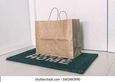 Home delivery of food grocery bag left at door mat for Corona virus spreading safety. Precaution measures against COVID-19, paper bag delivered without contact.