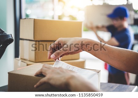 Home delivery service and working service mind, Woman working barcode scan to confirm sending customer in post office.