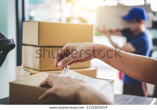 Home\
delivery service and working service mind, Woman working barcode\
scan to confirm sending customer in post\
office.