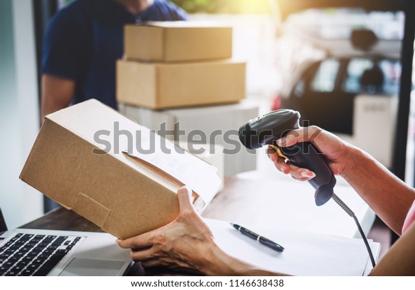 Home
delivery service and working service mind, Woman working barcode
scan to confirm sending customer in post
office.