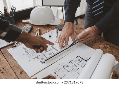 The home design architects are reviewing the house plan draft, the project commissioned by the client, and the custom design before delivery. Interior design and decoration ideas. - Powered by Shutterstock