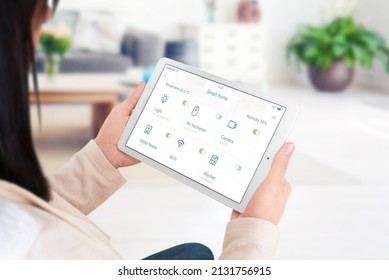 Home Devices Control On Modern Smart Home App On Tablet Display In Woman Hand Concept