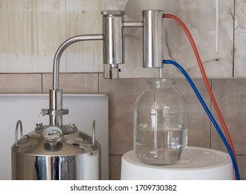 Home distillation equipment for the distillation of alcohol into glass jar - Powered by Shutterstock