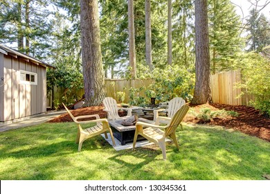 Home Exterior Backyard With Chairs And Pine Trees. Spring.