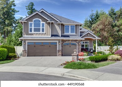 Home Exterior With Garage And Driveway With Nice Landscaping Desing Around