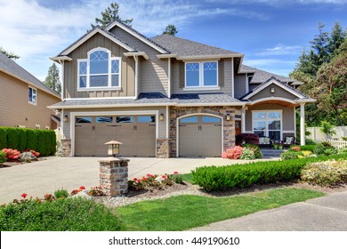 Home exterior with garage and driveway with nice landscaping desing around
