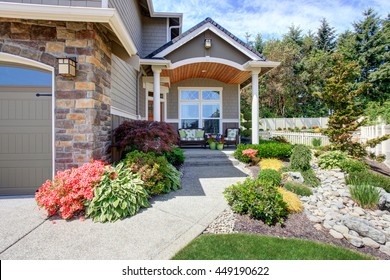 Home exterior with garage and driveway, patio area with nice landscaping desing around