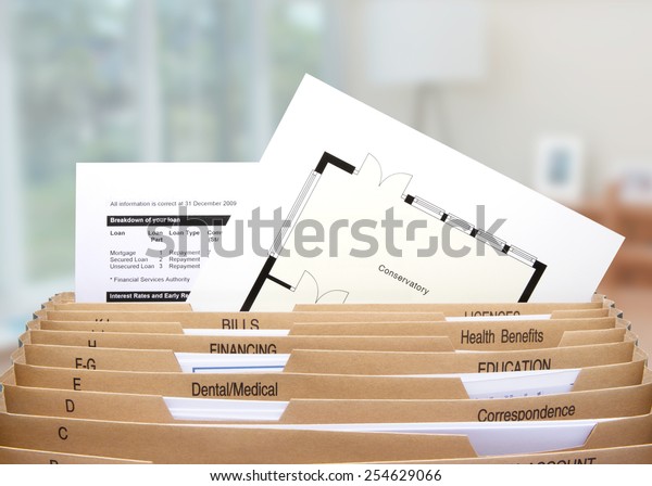 home filing dividers showing mortgage statements\
& house floor plan