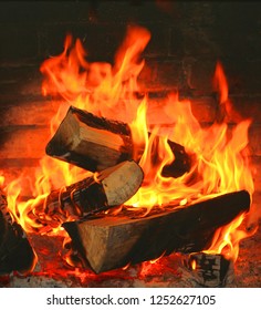 Home Fireplace With Beautiful Orange Fire And Wood Fire Close-up As Home Comfort And Hearth