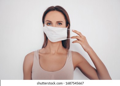 Home fitness. Young fit slim woman in sportswear protection face mask posing during self isolation quarantine. COVID-19 concept to promote stay safe home save lives. Free space for text mockup banner - Powered by Shutterstock