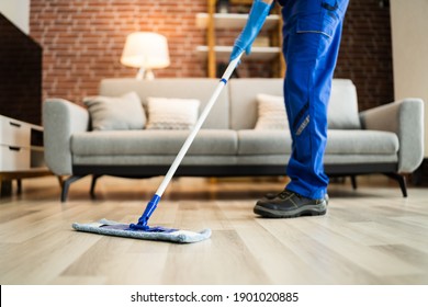 Home Floor Cleaning Service. Man Mopping Living Room