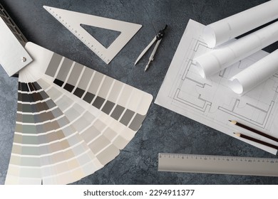 Home floor plans or building blueprint project and open color palette guide catalog with colour swatches. Architect or interior design concept. Choosing paint colors for house, flat or apartment.