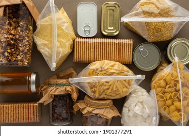 Home food supplies, necessary food for the period of quarantine and isolation, the concept of stay at home, canned food , various pasta and flour, sugar and cookies, top view - Shutterstock ID 1901377291