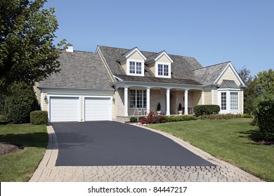 Home With Front Porch And Partial Brick Driveway