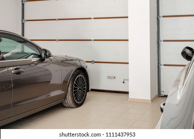 Home Garage For Two Vehicles Interior. Clean Luxury Cars Parked At Home. Automatic Remote Control Doors. Transport Roofed Storage