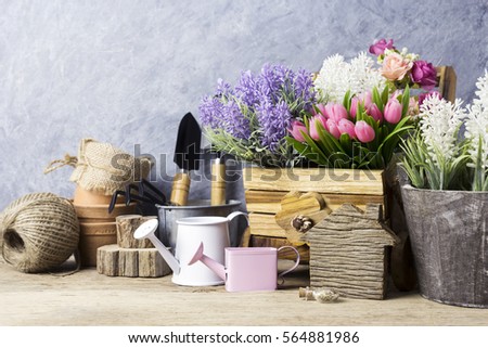 Home and garden concept of gardening tools and flowers on the old wood