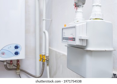 Home Gas Meter Against The Background Of An Autonomous Heating Boiler In The Kitchen Of The Apartment