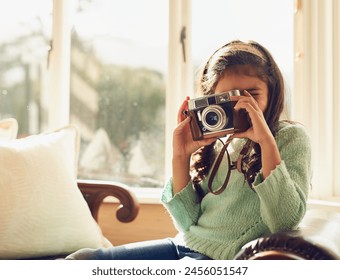 Home, girl and child with vintage camera, photography and memory with fun, playful and relax in living room. Apartment, retro or kid taking picture, creative and hobby with lens, learning or creative - Powered by Shutterstock