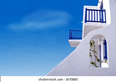A home in the Greek Islands with a beautiful blue sky.