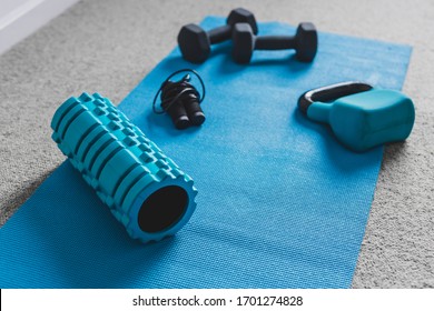 Home Gym Concept, Room With Dumbbells Kettlebell Foam Roller And Push-up Handles On Yoga Mat To Workout From Home