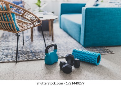 Home Gym And Exercising Indoor Concept, Set Of Fitness Gear On Living Room Carpet Next To The Couch In A Living Room Shot At Shallow Depth Of Field