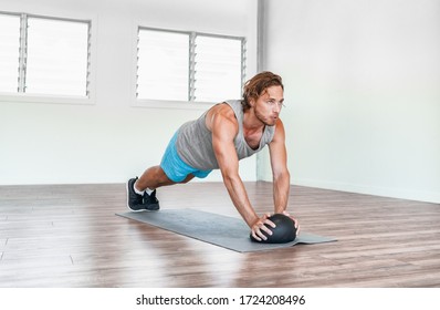 Home gym medicine ball workout abs exercise stability body exercises man training tricep pushups.