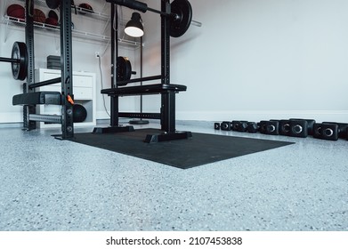 Home Gym With Weight Rack, Bench, Dumbbells, Resistance Bands In The Garage.