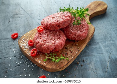 Home HandMade Raw Minced Beef steak burgers on wooden board. - Powered by Shutterstock