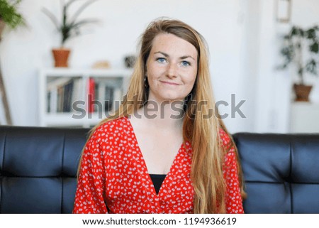 Similar – Entrepreneur woman wearing red shirt working with a laptop sitting on a couch at home