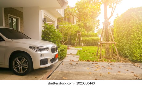 Home Happy Concept . Beautiful Exterior Of Newly Built Luxury Home And Car Park At Warm Morning Light .