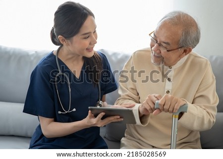 Home health care nurse caregiver take care senior elderly man at home she showing the health care madicine program and explain the previous report to retirement oldman 


