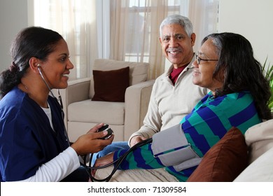 Home Health Care Worker And An Elderly Couple