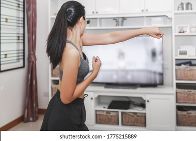 Home healthy exercise concept, Asian fit woman stay home and training online sport workout class on tv at home, New normal life of covid-19 outbreak