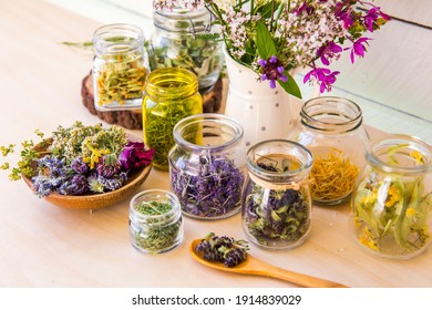 Home herbal apothecary concept. Lot of different dry herbal remedy plants( Chamaenerion angustifolium, Achillea millefolium, Tilia platyphyllos, Prunella vulgaris, Equisetum arvense in containers.
