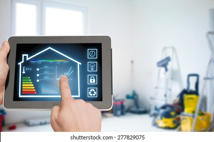home, housing, people and technology concept - close up of man hands pointing finger to tablet pc computer and regulating room temperature over storeroom or building background - Shutterstock ID 277829075