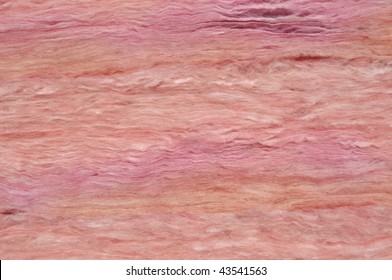 Home improvement: Close-up of pink fiberglass insulation material.