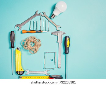 Home improvement concept. Set work hand tool for construction or repair of house. Rebuilding DIY. Group of tools in shape house.