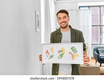 Home Improvement, Decoration And Art Concept - Happy Smiling Man Holding Watercolor Picture In Frame