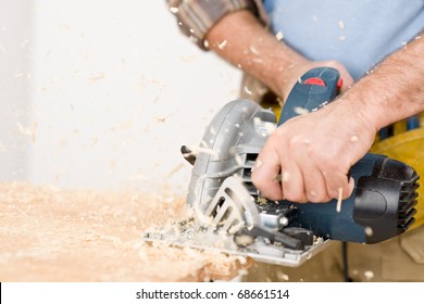 Home Improvement - Handyman Cut Wood With Jigsaw In Workshop